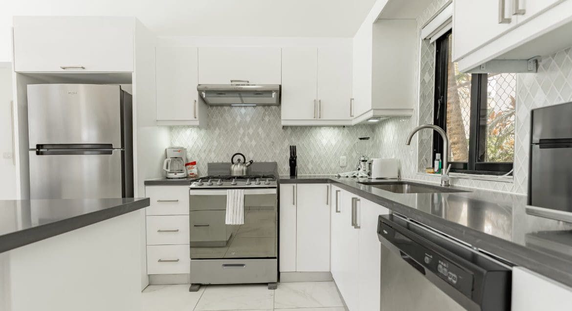 buyDRproperty Modern white kitchen with stainless steel appliances. Beautiful Villa CAPRI. Sosua Real Estate