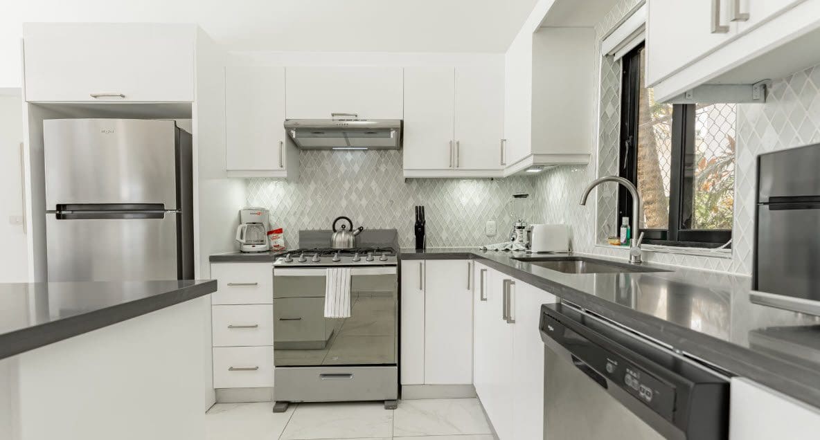 buyDRproperty Modern white kitchen with stainless steel appliances. Beautiful Villa CAPRI. Sosua Real Estate