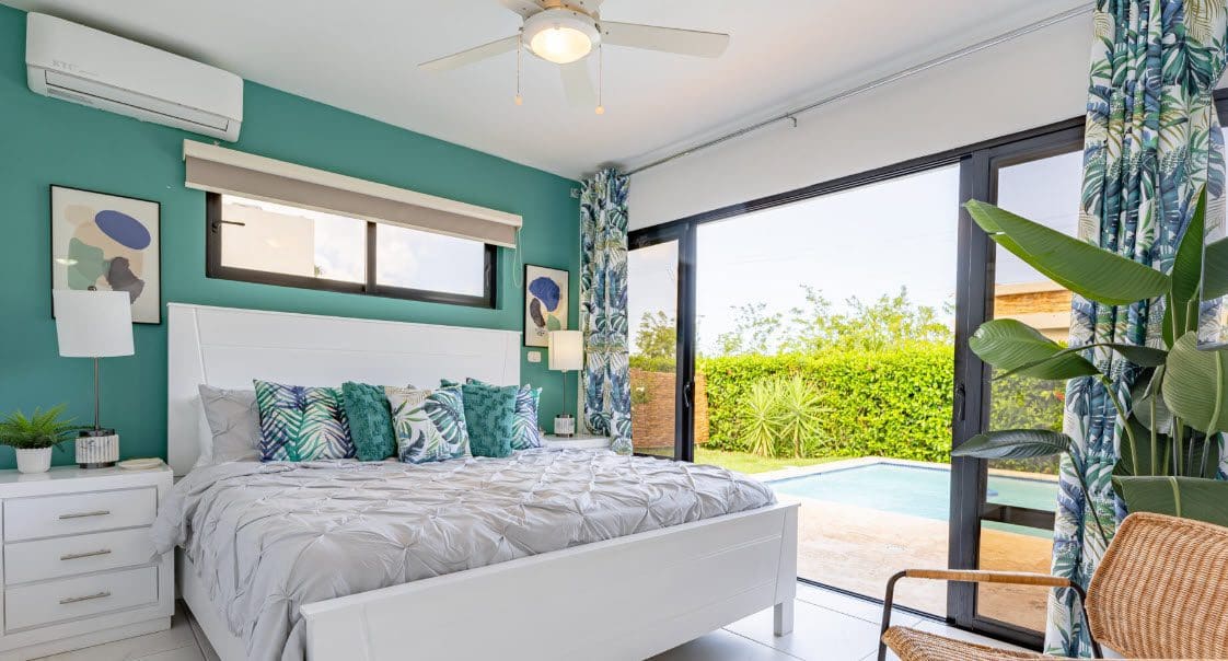 buyDRproperty Beautiful Villa CAPRI bedroom with tropical decor and pool view. Sosua Real Estate