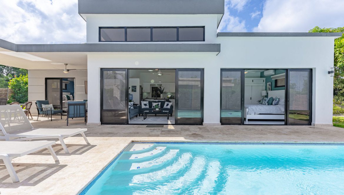 buyDRproperty Beautiful Villa CAPRI with pool and open doors to the living room and bedroom. Sosua Real Estate