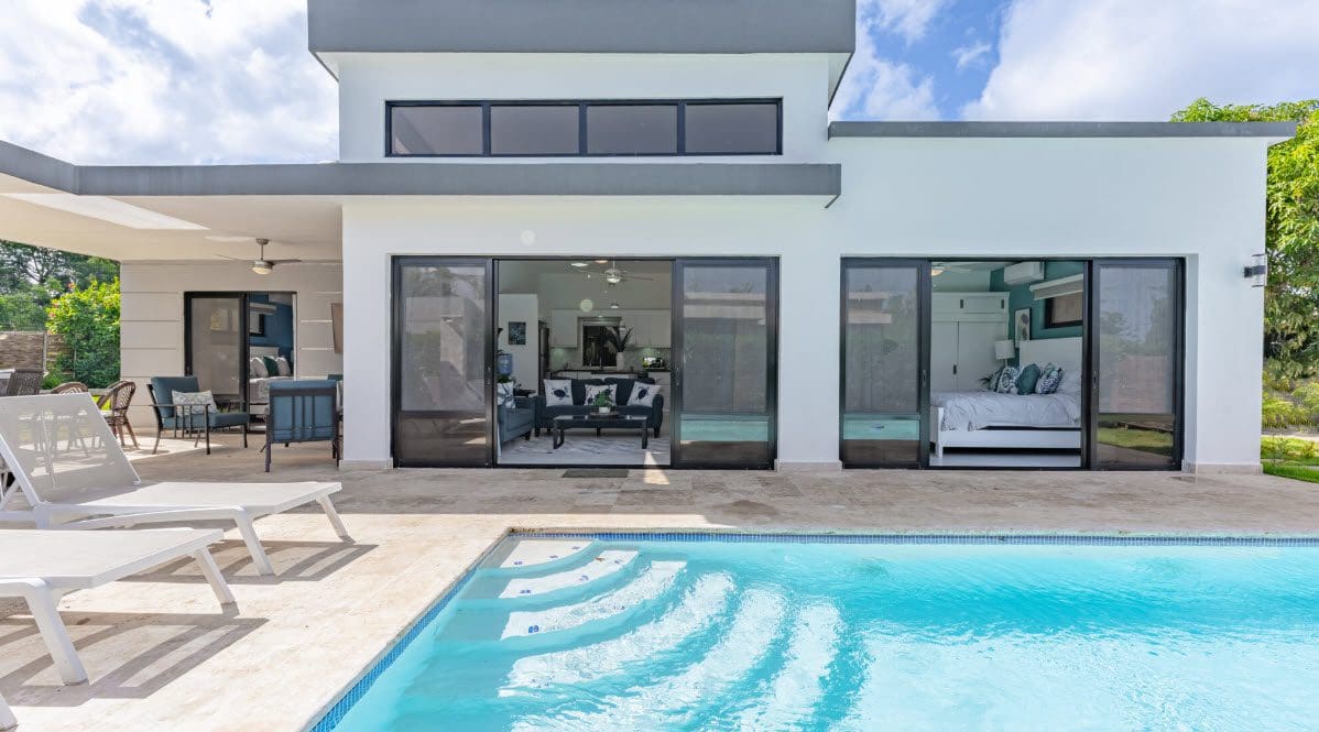 buyDRproperty Beautiful Villa CAPRI with pool and open doors to the living room and bedroom. Sosua Real Estate