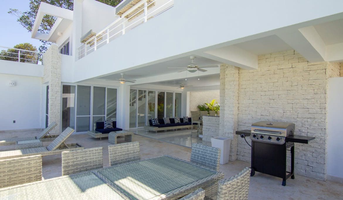 buyDRproperty Beautiful Villa SEASHELL outdoor patio in Casa Linda with grill and seating. Sosua Real Estate