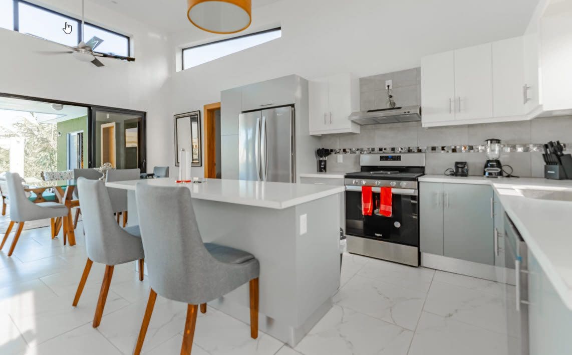 buyDRproperty Modern kitchen in Casa Linda villa SUNSEEKER with breakfast bar and stainless steel appliances. Sosua Real Estate