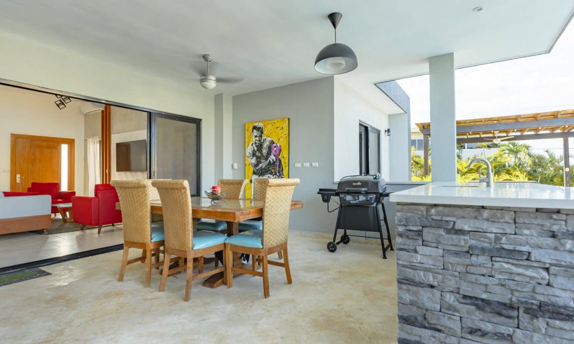 buyDRproperty Outdoor dining area of a Beautiful Villa SUNSEEKER in Casa Linda with a grill and painting. Sosua Real Estate