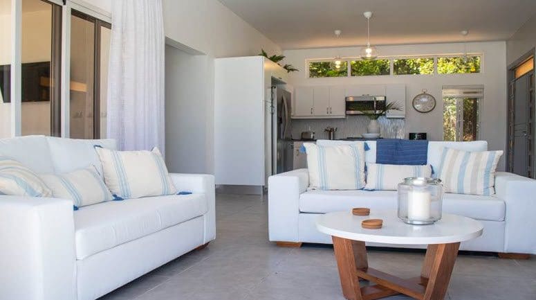 buyDRproperty Living room of a beautiful villa SUNBREEZE with white sofas and decor. Sosua Real Estate