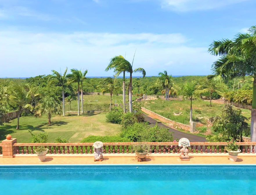 buyDRproperty Ocean view from a beautiful 5 bedroom villa with a pool and palm trees. Sosua Real Estate