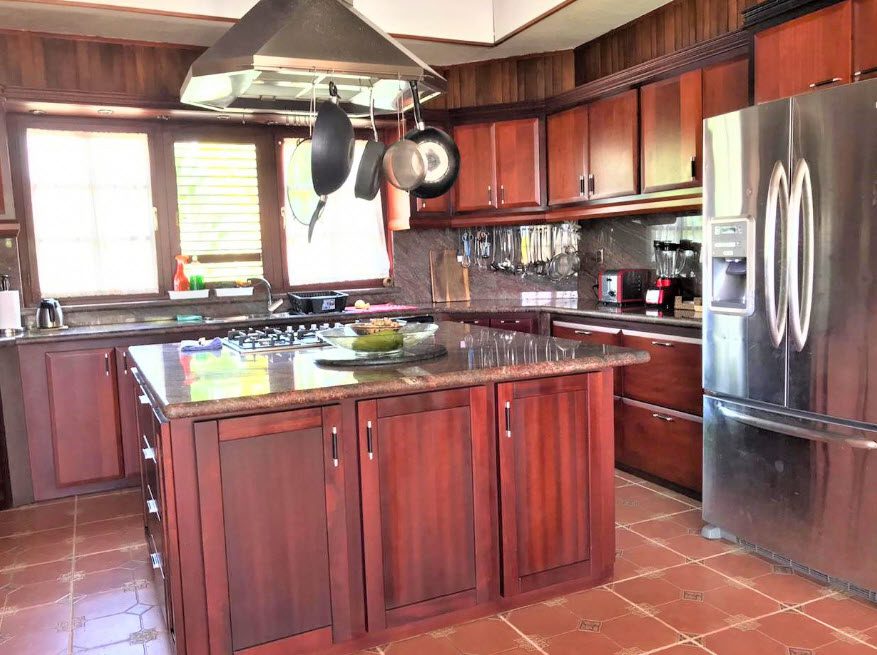 buyDRproperty Elegant kitchen in a beautiful 5 bedroom villa with island and stainless steel appliances. Sosua Real Estate
