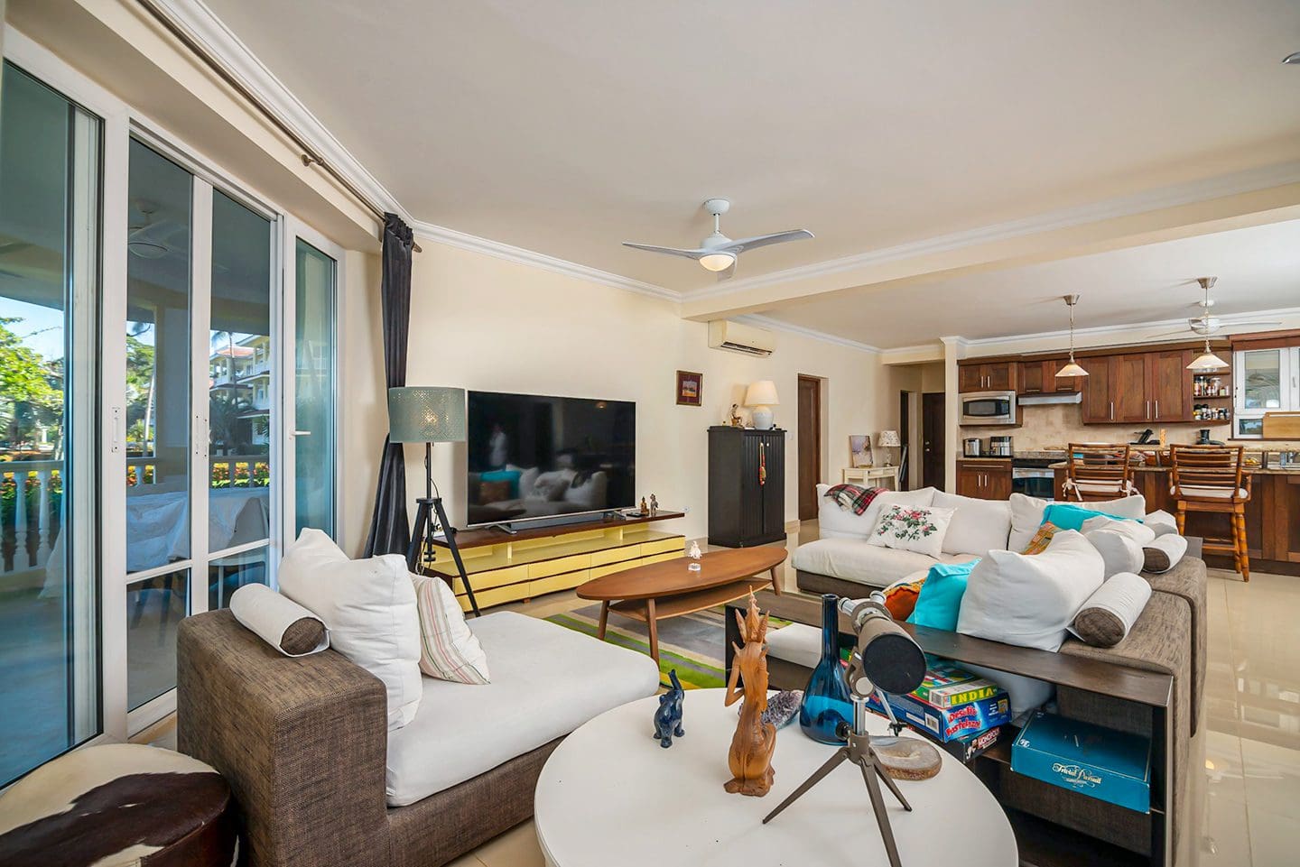 buyDRproperty Living room of an oceanfront condo in Sosua with a TV and modern furniture. Sosua Real Estate