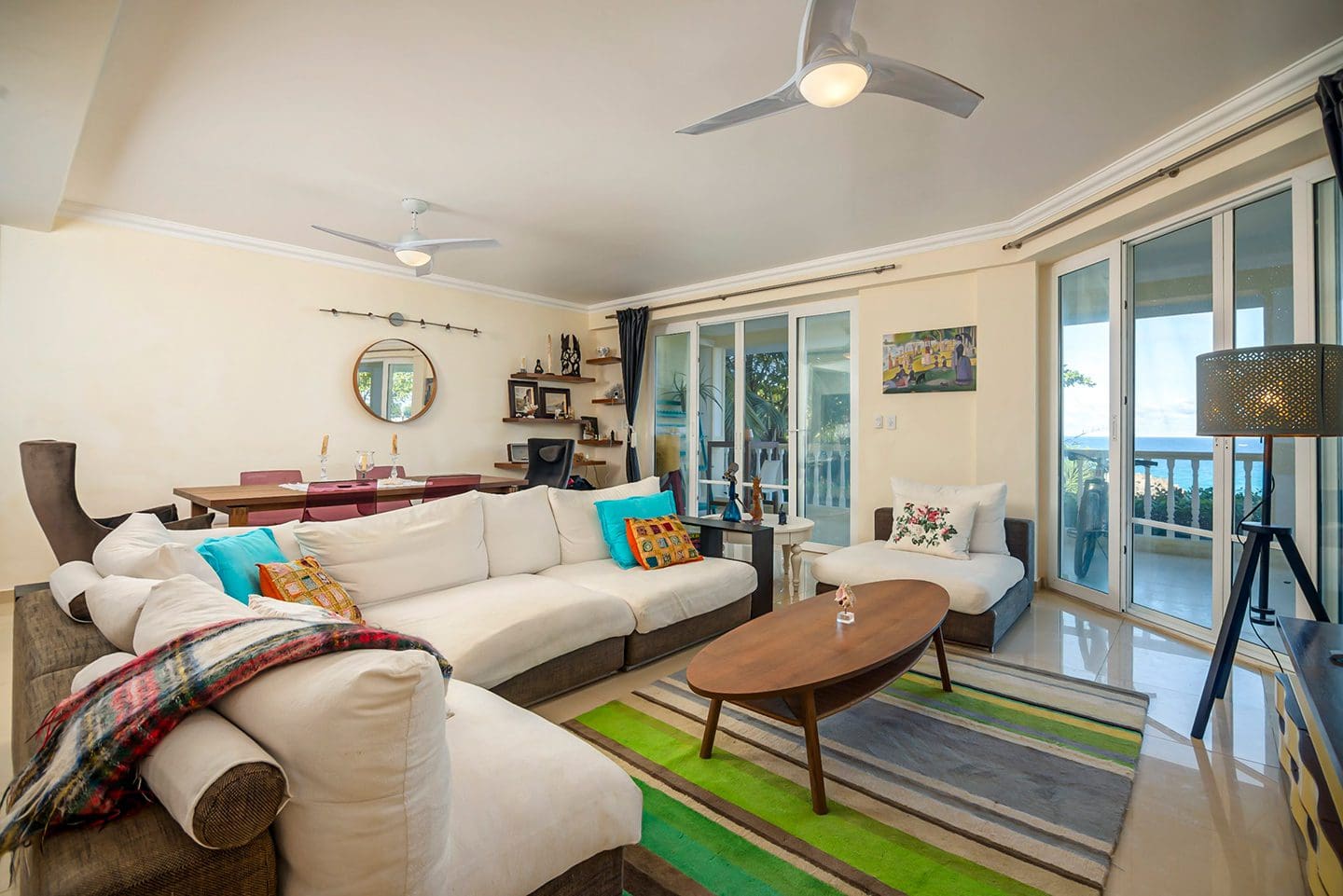 buyDRproperty Oceanfront condo living room in Sosua with white sofa and ocean views Sosua Real Estate