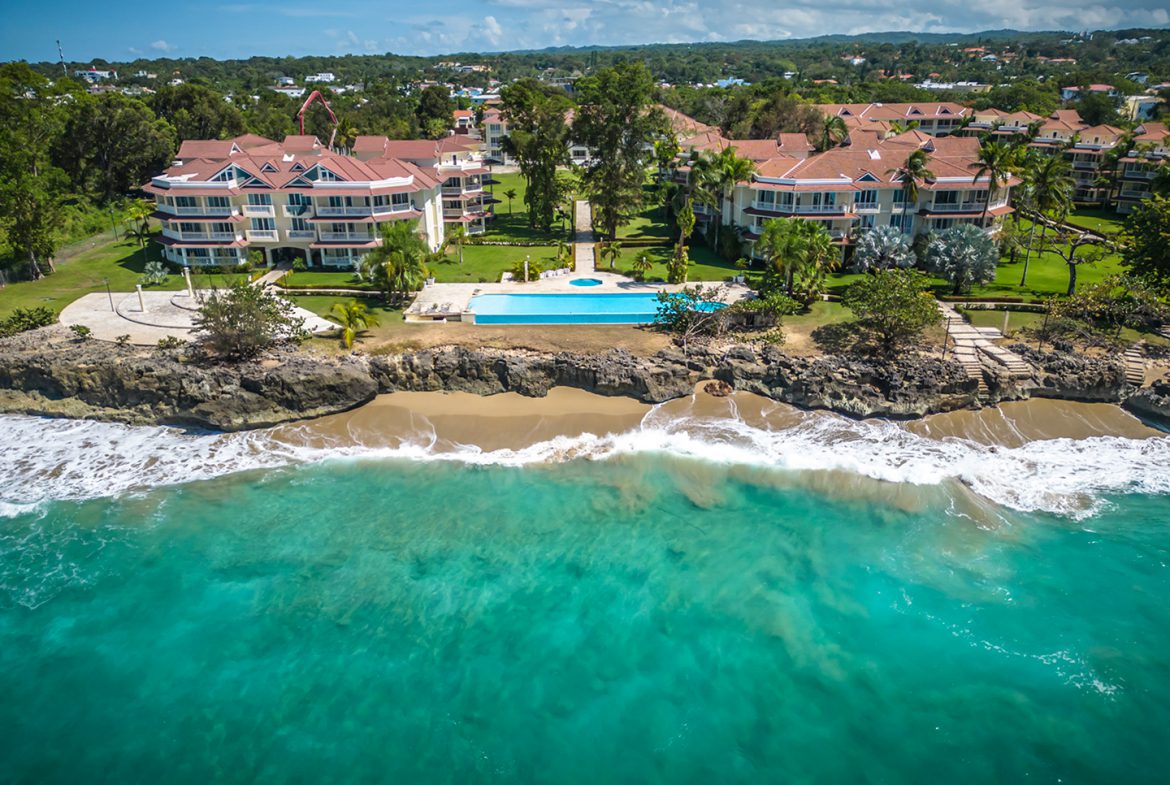 buyDRproperty Oceanfront condo in Sosua with a turquoise ocean and a swimming pool Sosua Real Estate