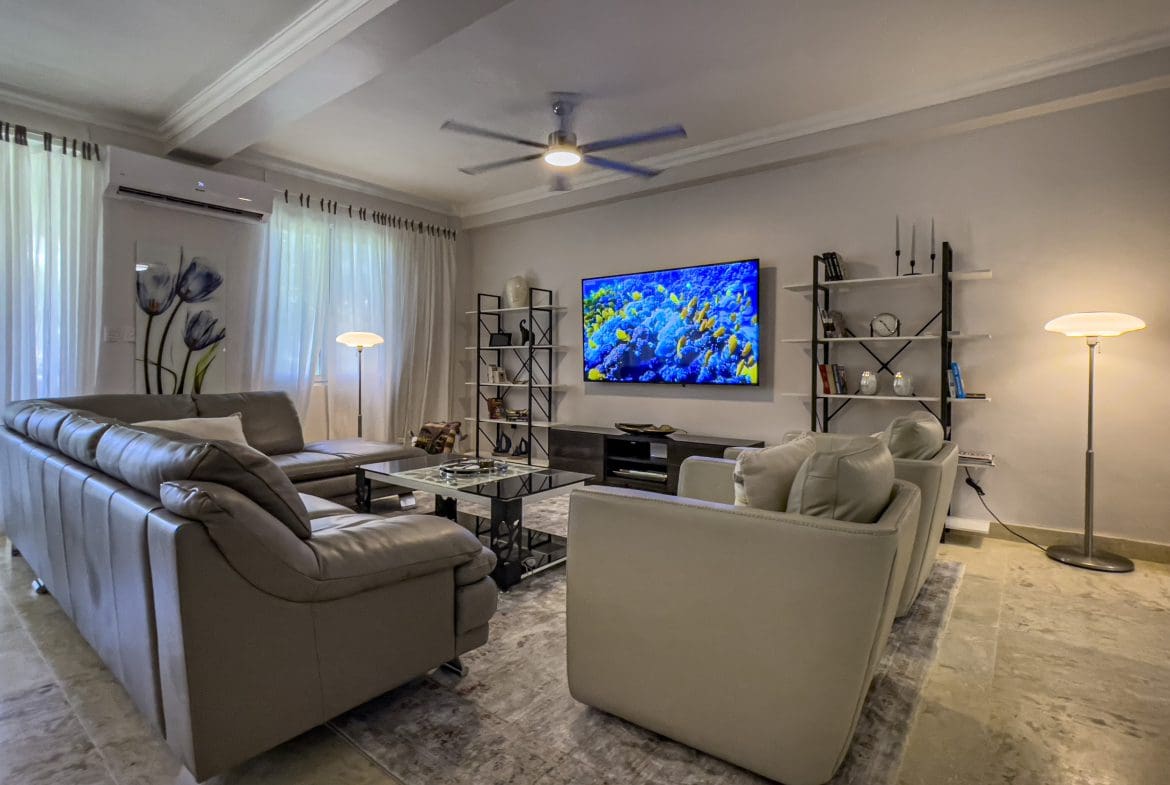 buyDRproperty Living room of a 3 bedroom oceanfront condo, featuring modern furniture and decor. Sosua Real Estate