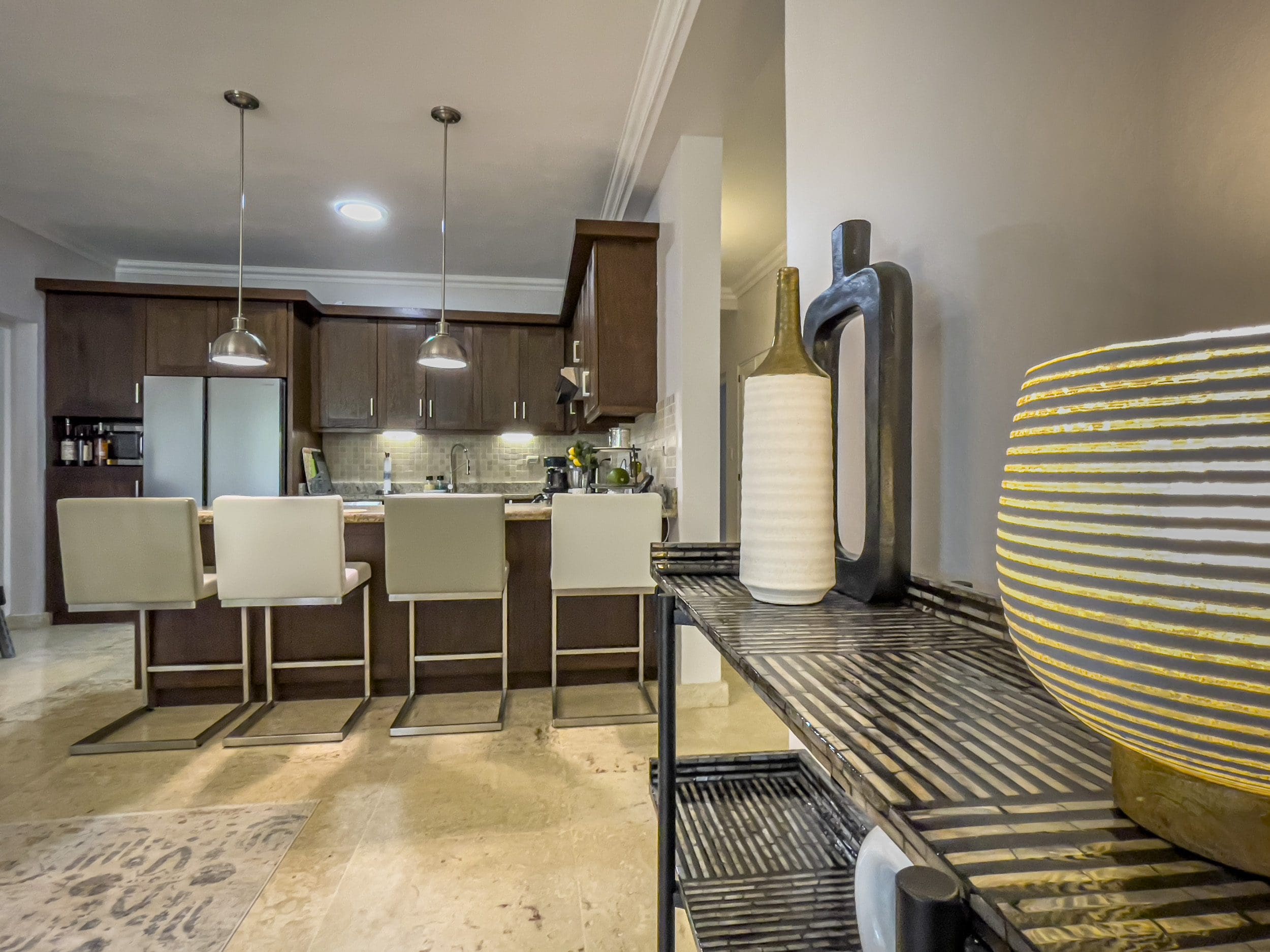 buyDRproperty Modern kitchen with bar seating in a 3 bedroom oceanfront condo. Sosua Real Estate