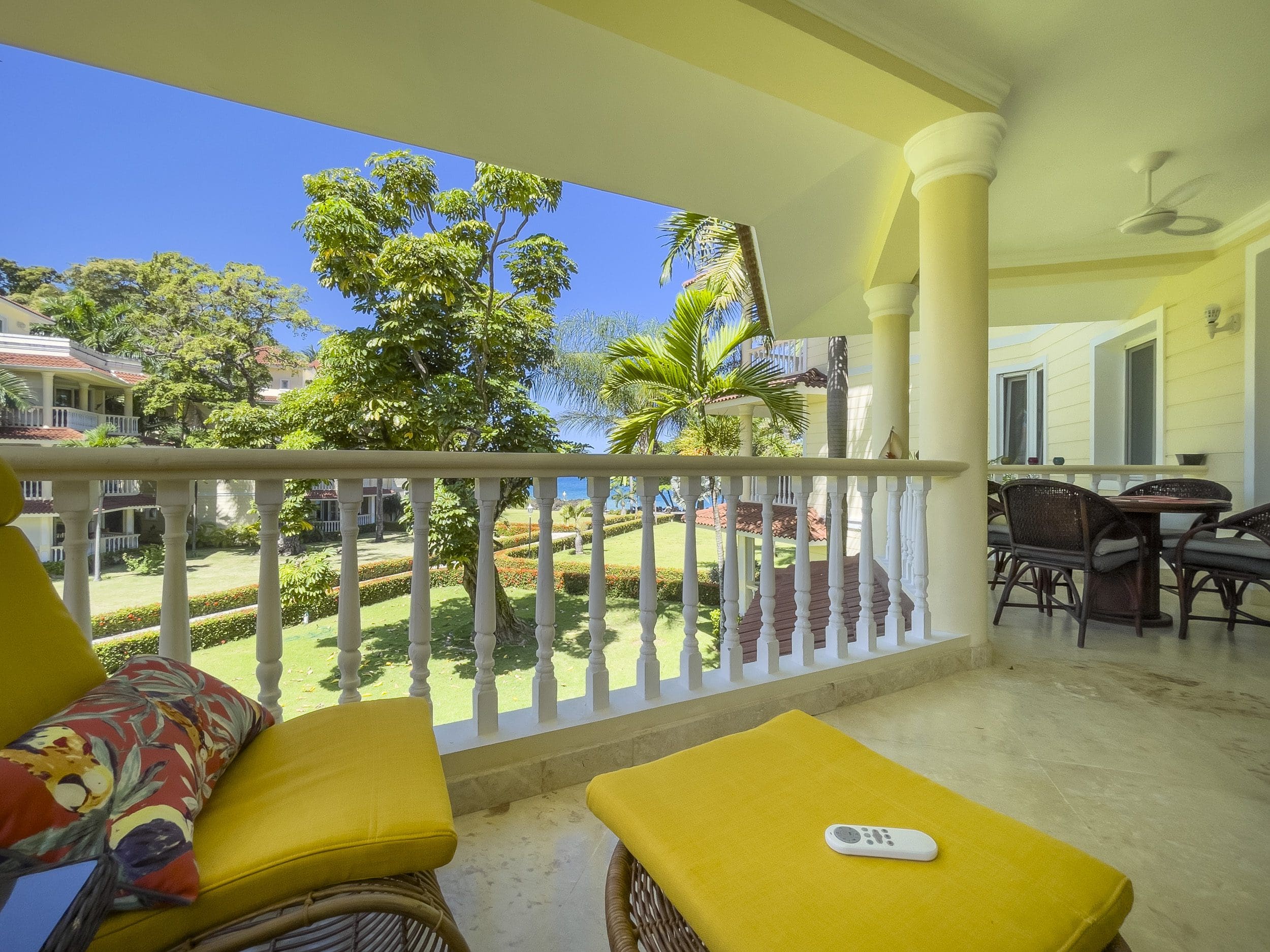 buyDRproperty Balcony of a 3 bedroom oceanfront condo with views of the ocean and lush greenery. Sosua Real Estate