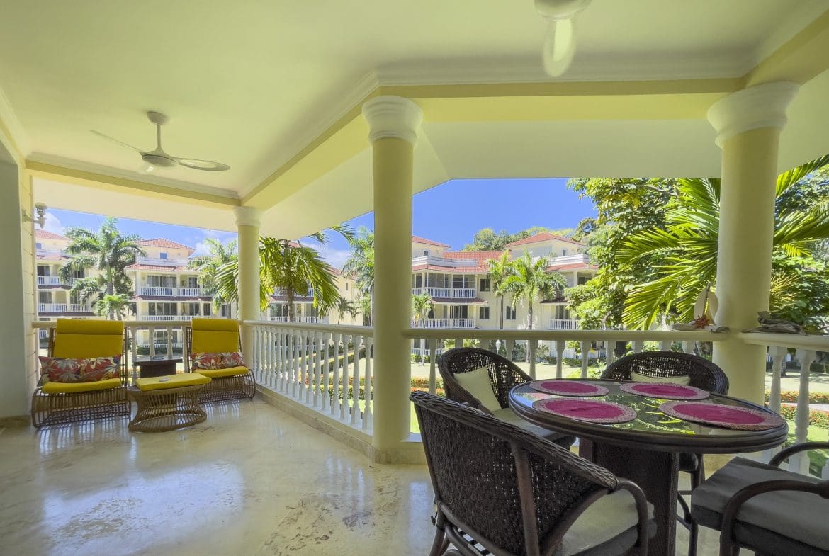 buyDRproperty Balcony of a 3 Bedroom Oceanfront Condo overlooking buildings. Sosua Real Estate