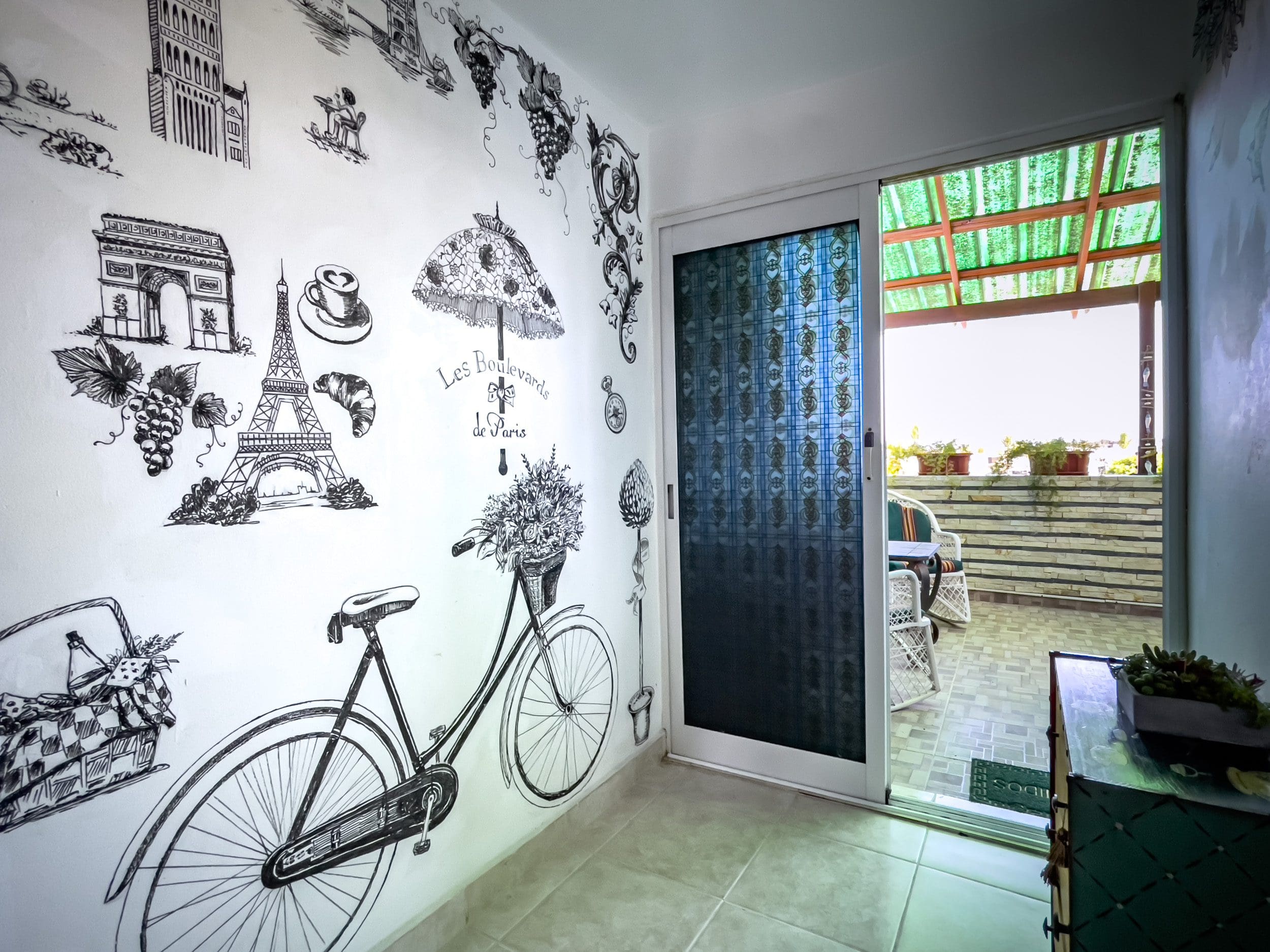 buyDRproperty Parisian wall art and balcony view in a 2 bedroom condo in the heart of Sosua. Sosua Real Estate