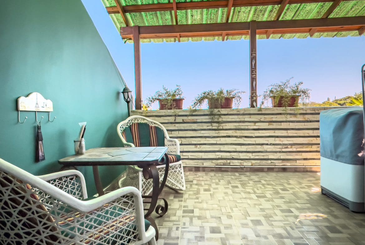 buyDRproperty Outdoor patio with seating, table, and blue sky, perfect for a 2 bedroom condo in the heart of Sosua. Sosua Real Estate