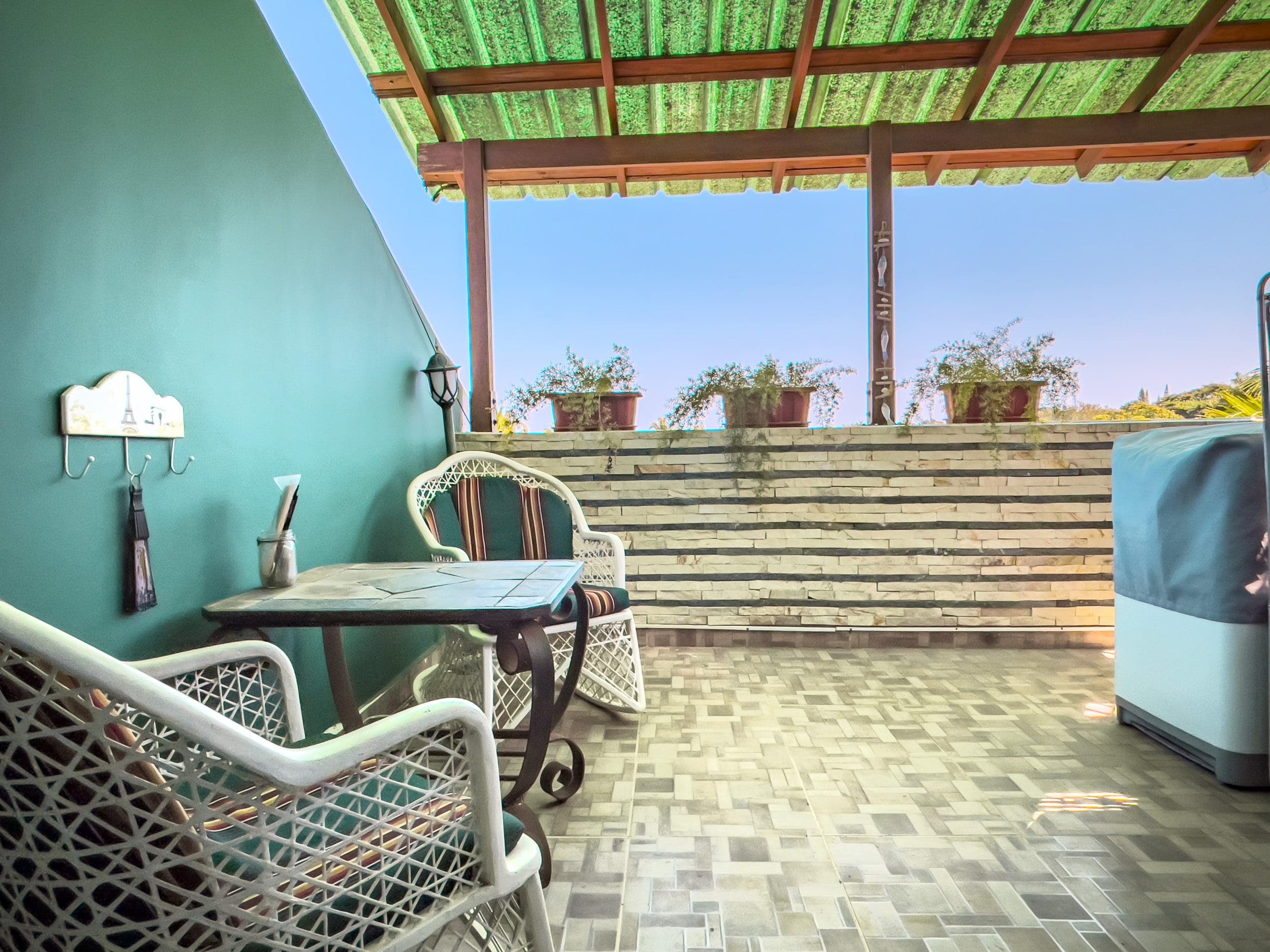 buyDRproperty Outdoor patio with seating, table, and blue sky, perfect for a 2 bedroom condo in the heart of Sosua. Sosua Real Estate