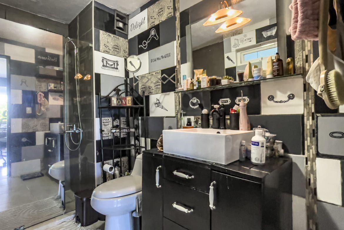 buyDRproperty Black and white bathroom with sink and toilet. 2 Bedroom Condo in the heart of Sosua. Sosua Real Estate