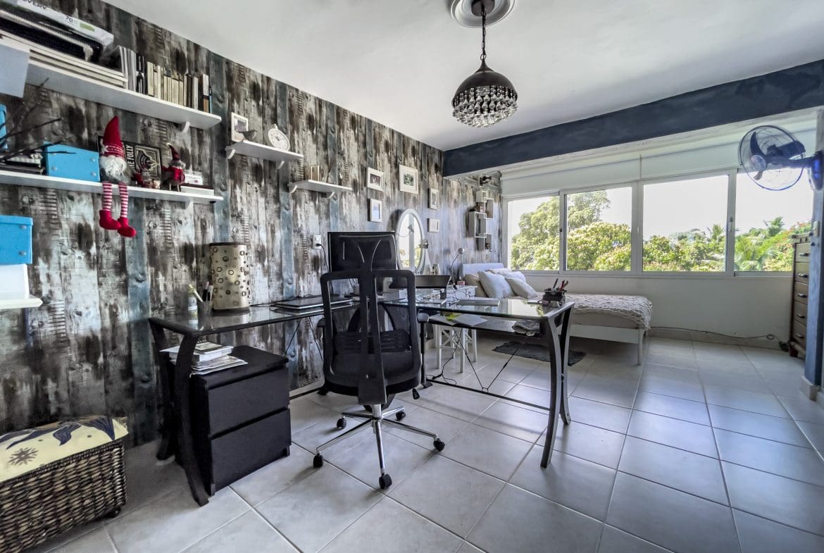 buyDRproperty Home office in a 2 bedroom condo in the heart of Sosua with desk, chair, and shelves Sosua Real Estate