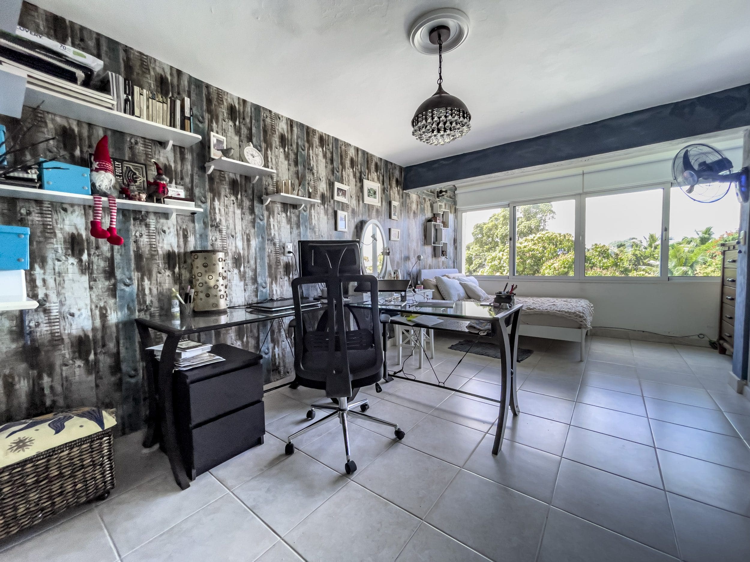 buyDRproperty Home office in a 2 bedroom condo in the heart of Sosua with desk, chair, and shelves Sosua Real Estate