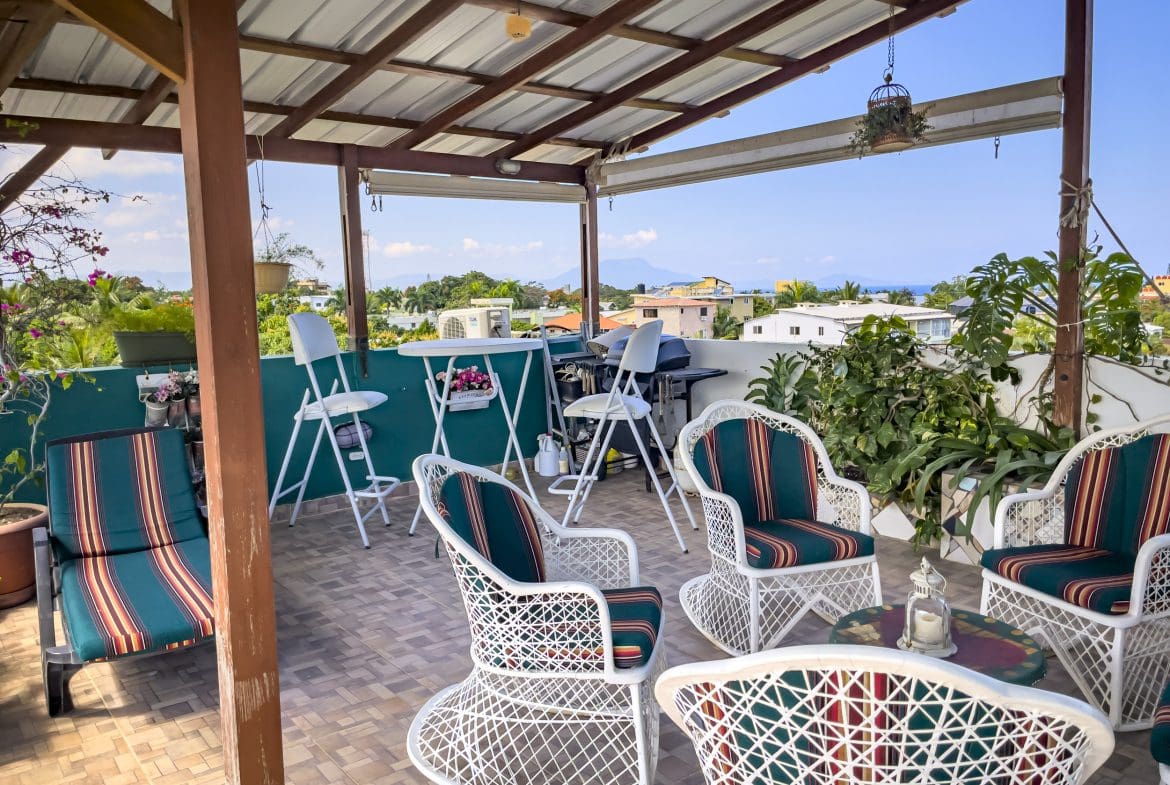 buyDRproperty Rooftop patio with white wicker furniture, perfect for a 2 Bedroom Condo in the heart of Sosua. Sosua Real Estate
