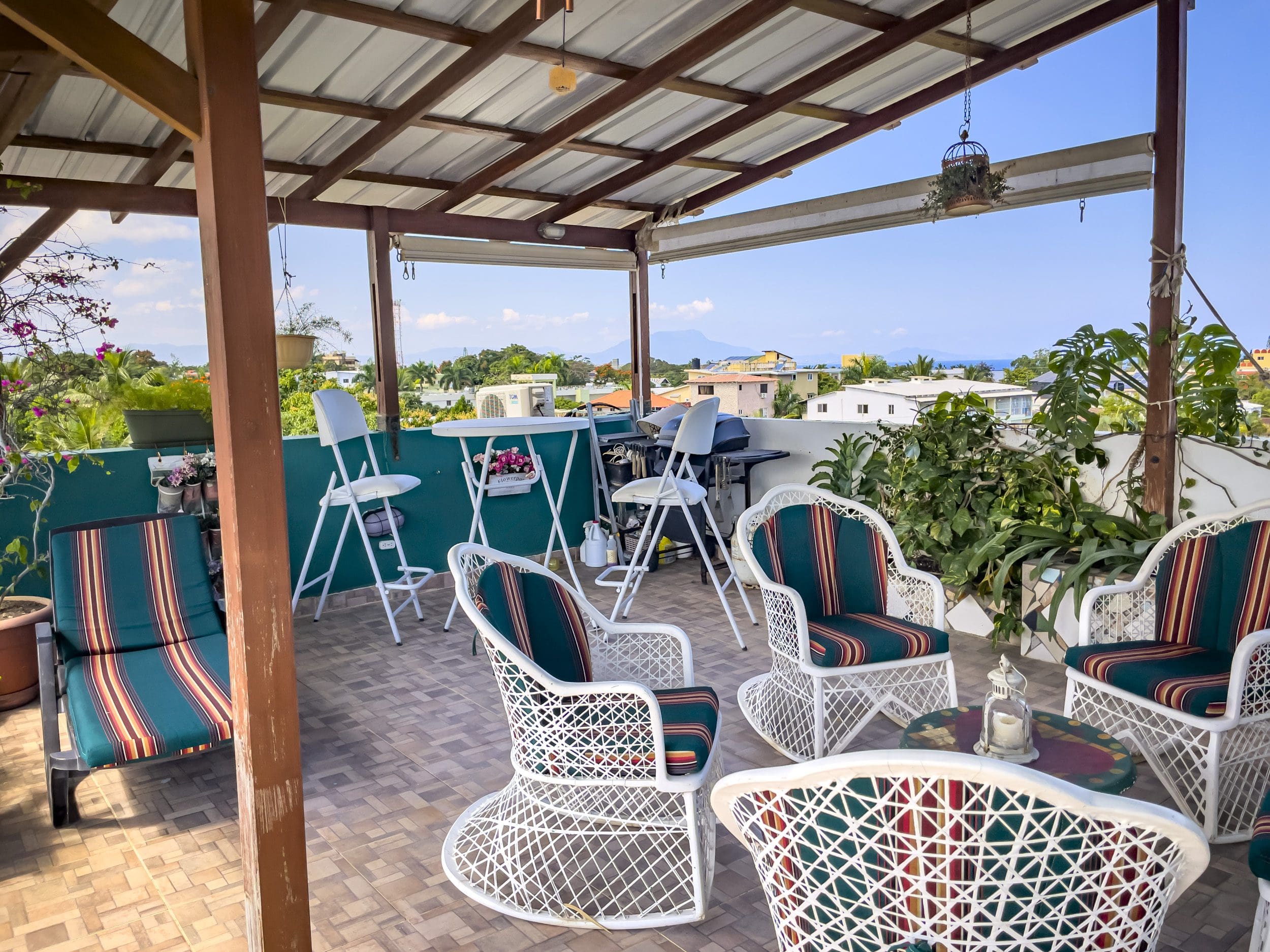 buyDRproperty Rooftop patio with white wicker furniture, perfect for a 2 Bedroom Condo in the heart of Sosua. Sosua Real Estate