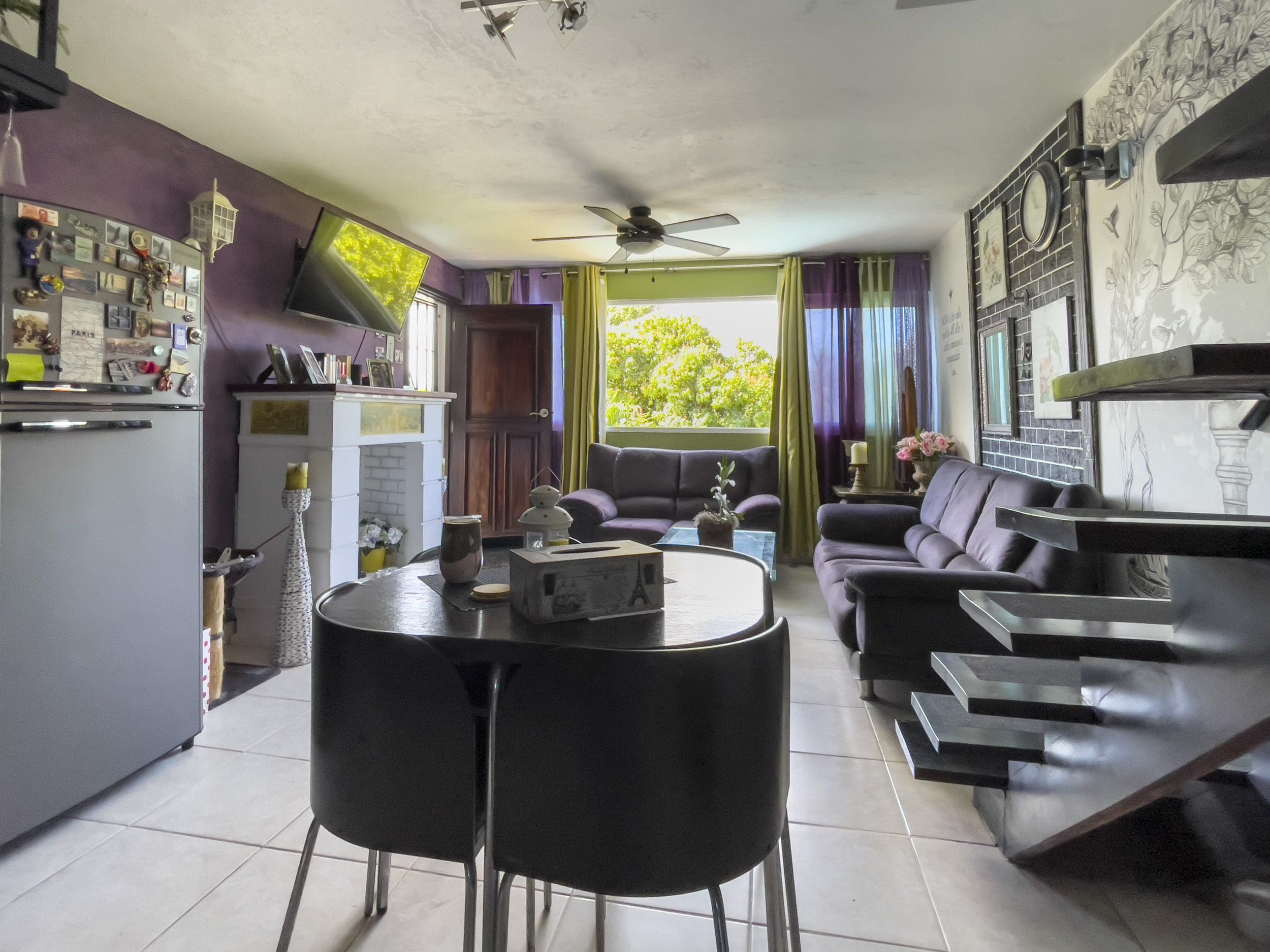 buyDRproperty Living room of a 2 Bedroom Condo in the heart of Sosua. Features a dining table and two sofas. Sosua Real Estate