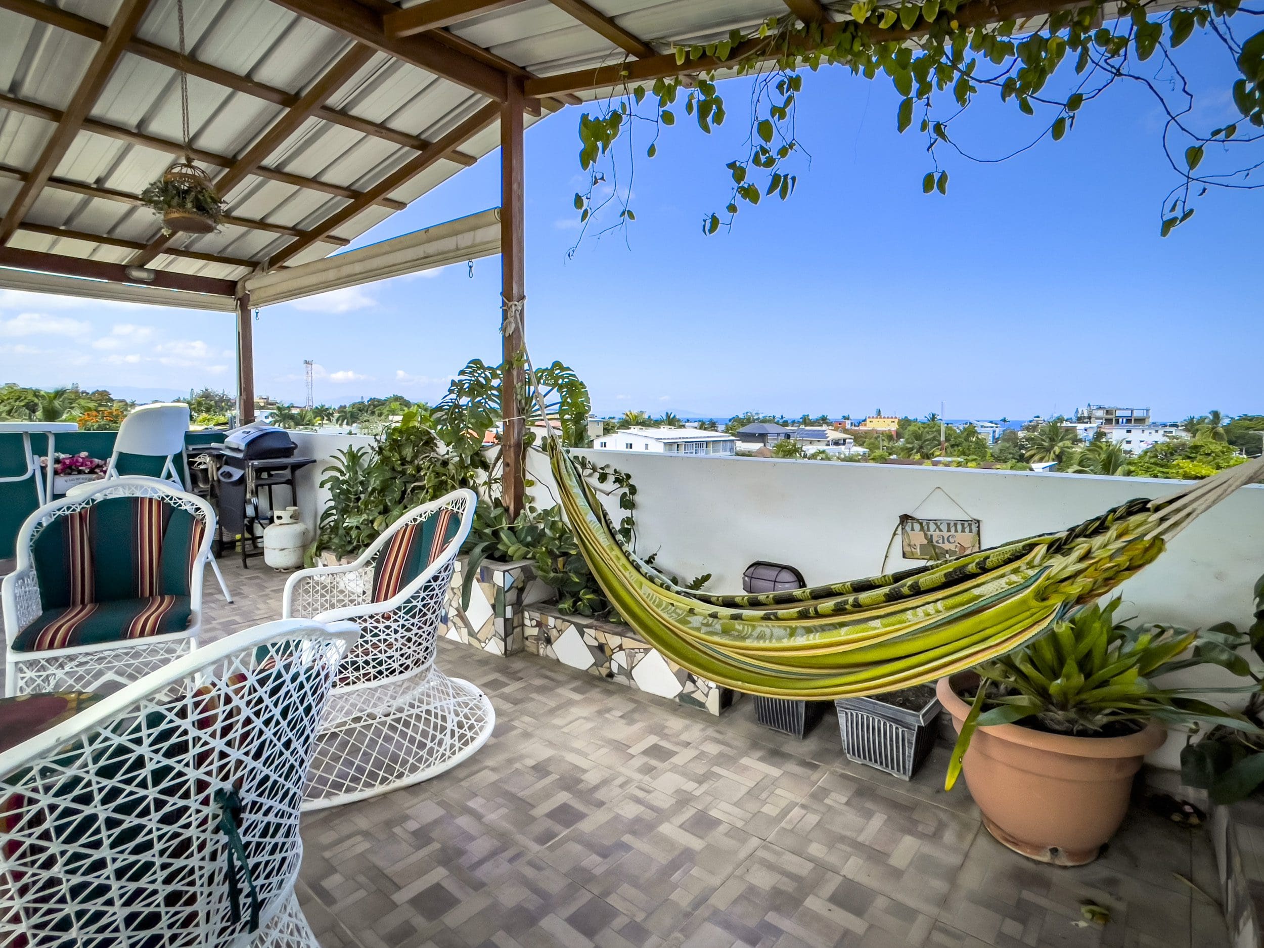 buyDRproperty Rooftop patio of a 2 bedroom condo in Sosua with hammock and chairs. Sosua Real Estate