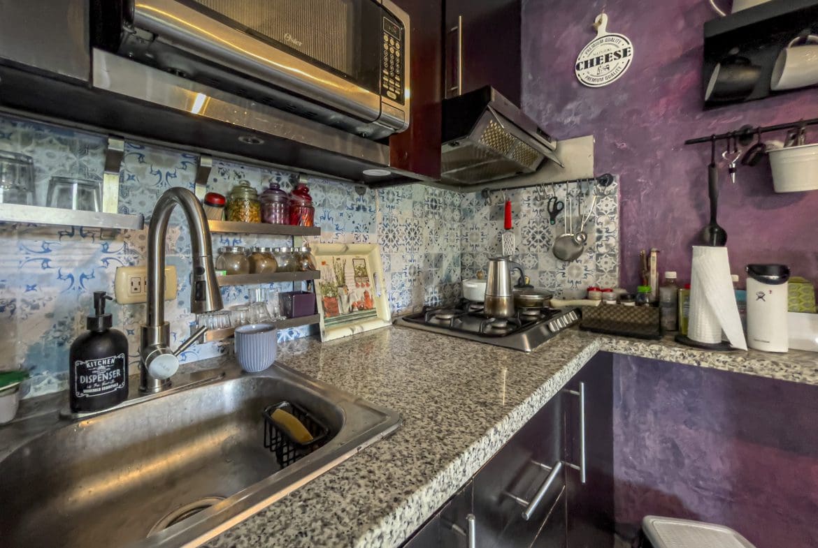 buyDRproperty Kitchen in a 2 Bedroom Condo in the heart of Sosua featuring a stainless steel sink and microwave. Sosua Real Estate