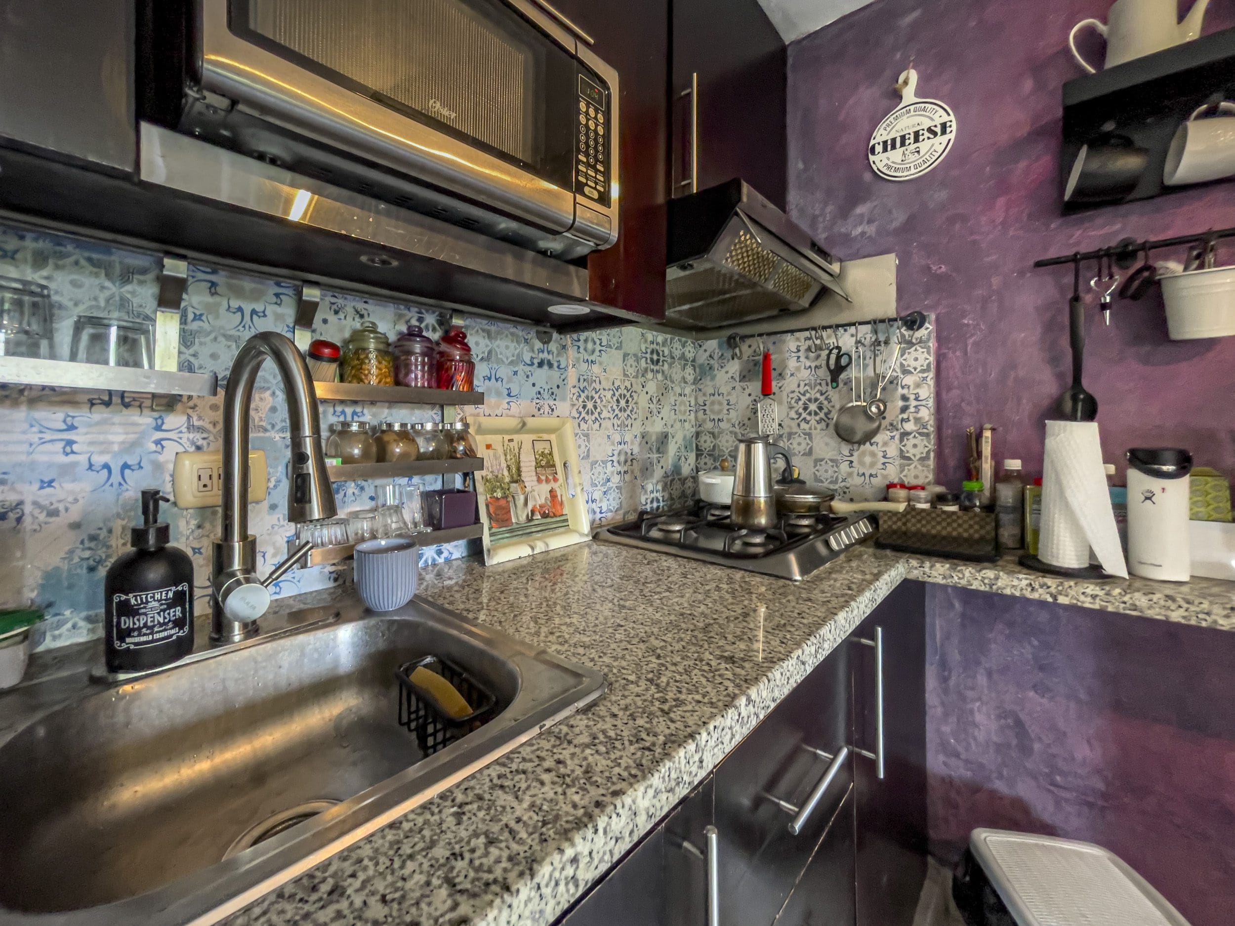 buyDRproperty Kitchen in a 2 Bedroom Condo in the heart of Sosua featuring a stainless steel sink and microwave. Sosua Real Estate