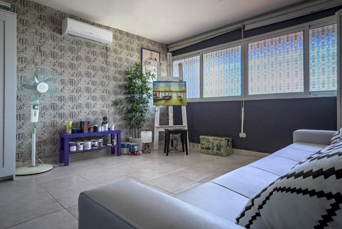 buyDRproperty Cozy 2 bedroom condo in Sosua artist's studio with painting on easel. Sosua Real Estate