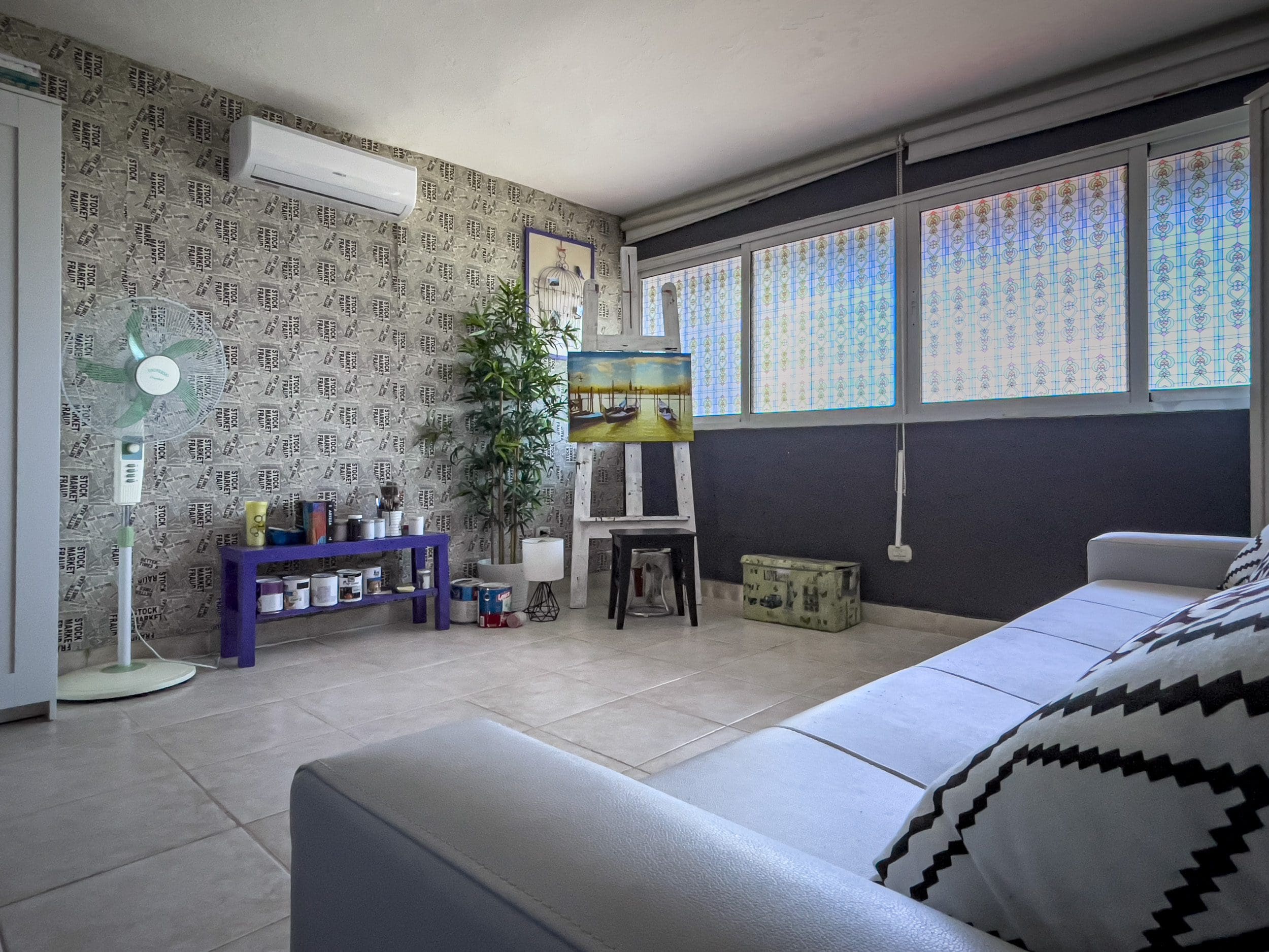 buyDRproperty Cozy 2 bedroom condo in Sosua artist's studio with painting on easel. Sosua Real Estate