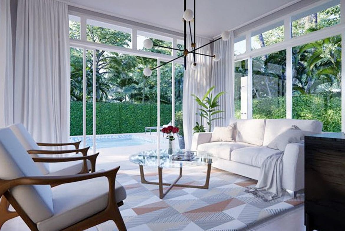 buyDRproperty Modern living room with large windows overlooking a lush garden. Beautiful Villa SUNSET Sosua Real Estate