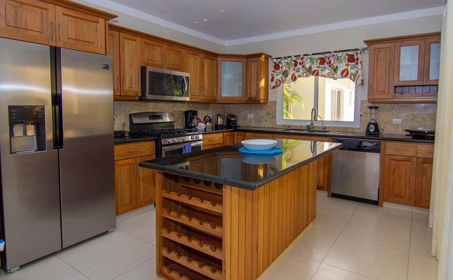 buyDRproperty Beautiful Villa BELLA kitchen with stainless steel appliances and wooden cabinetry in Casa Linda. Sosua Real Estate