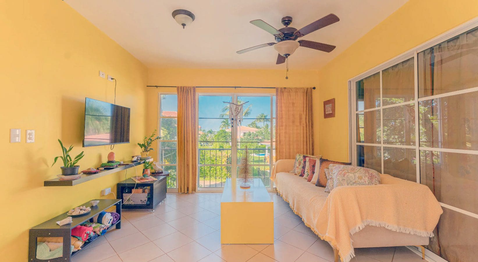 buyDRproperty Living room in a Hispaniola Two Unit Villa with yellow walls and a view. Residential Hispaniola. Sosua Real Estate