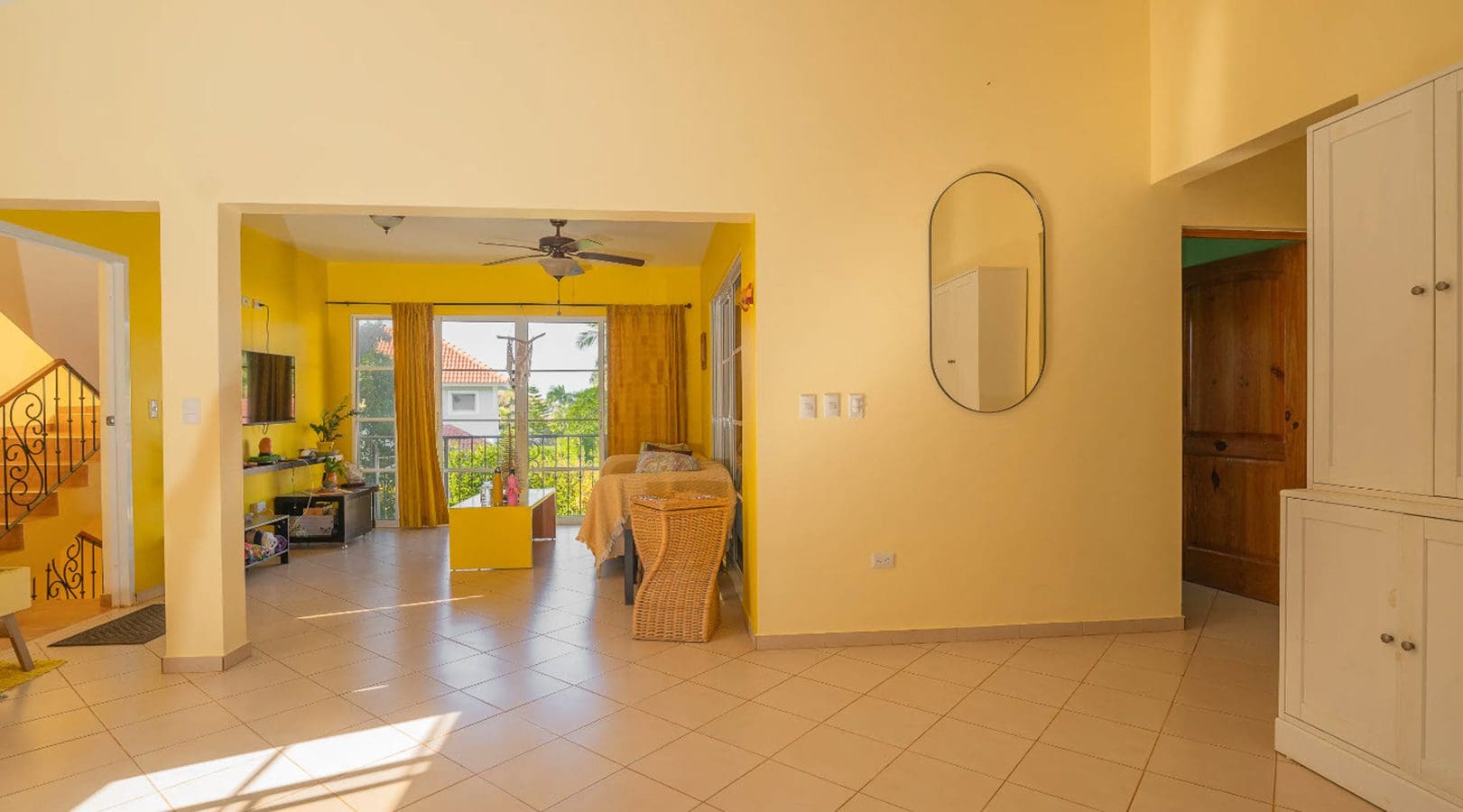 buyDRproperty Bright living room with yellow walls in a Hispaniola Two Unit Villa. Sosua Real Estate