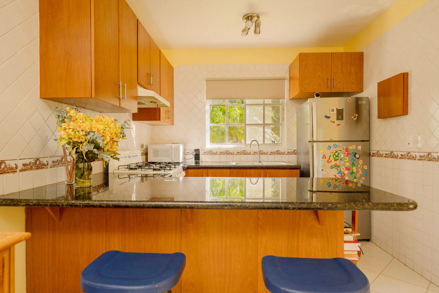 buyDRproperty Kitchen in a Hispaniola Two Unit Villa with breakfast bar and wooden cabinets. Sosua Real Estate