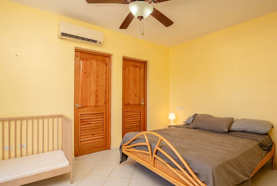 buyDRproperty Bedroom in a Hispaniola Two Unit Villa for sale, with bed and crib. Sosua Real Estate