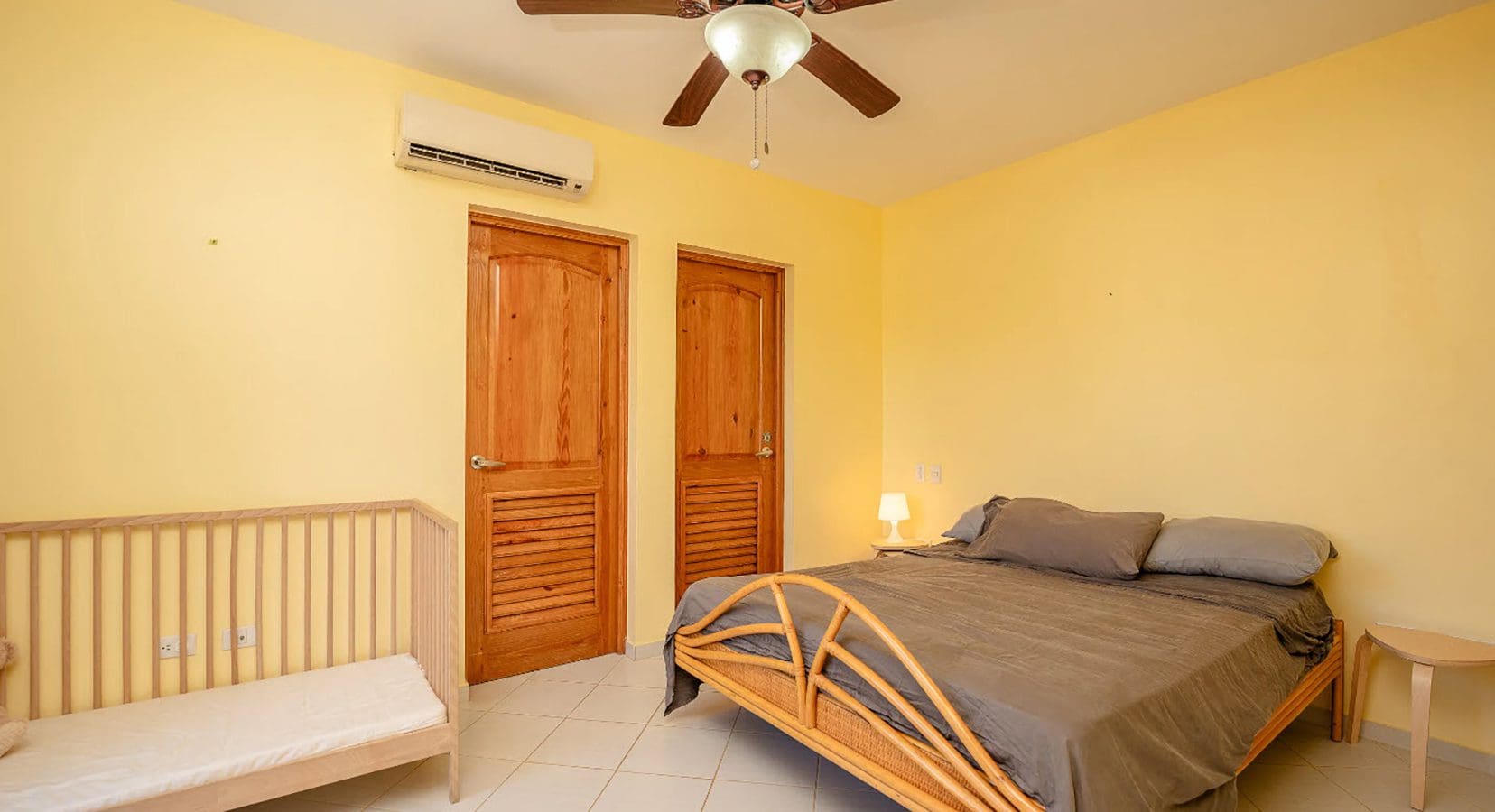 buyDRproperty Bedroom in a Hispaniola Two Unit Villa for sale, with bed and crib. Sosua Real Estate