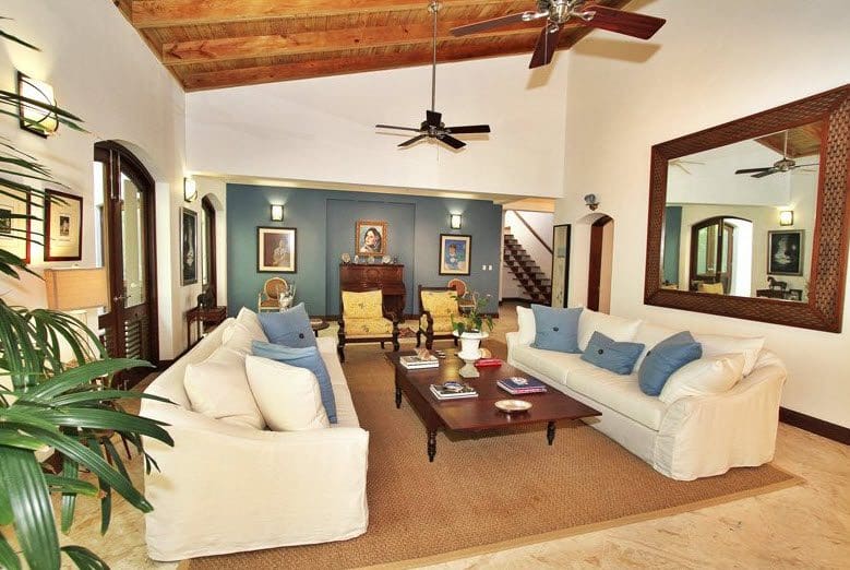 buyDRproperty Luxury living room with white sofas, wooden coffee table, and high ceilings. Sosua Real Estate