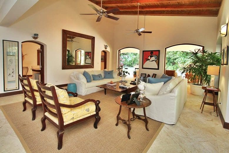 buyDRproperty Luxury living room in Villa CAROLINA with white sofa, artwork, and natural light. Sosua Real Estate