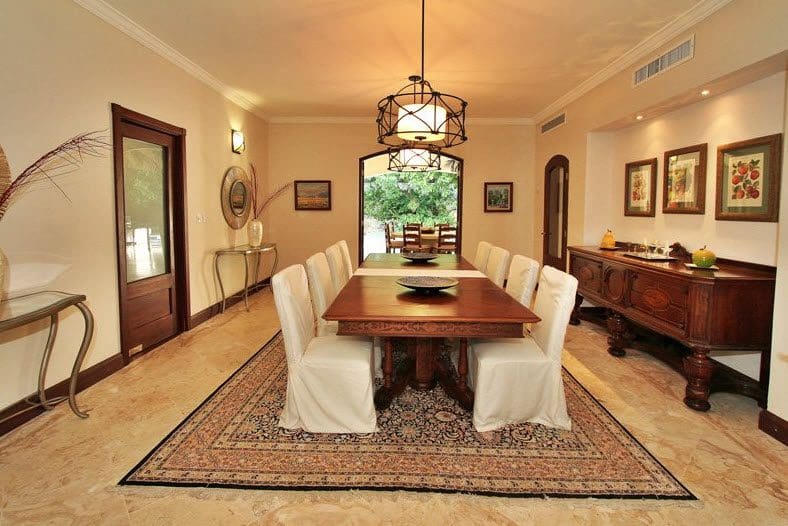buyDRproperty Luxury dining room with large wooden table, elegant chairs, and rug. Sosua Real Estate