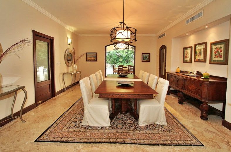 buyDRproperty Luxury dining room in Villa CAROLINA with a long wooden table and elegant chairs. Sosua Real Estate