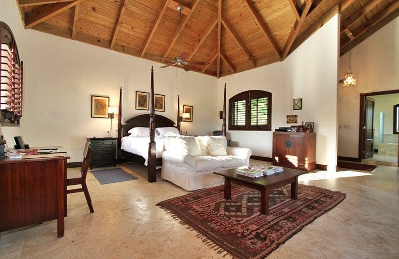 buyDRproperty Luxury bedroom in Villa CAROLINA with four-poster bed and white sofa Sosua Real Estate