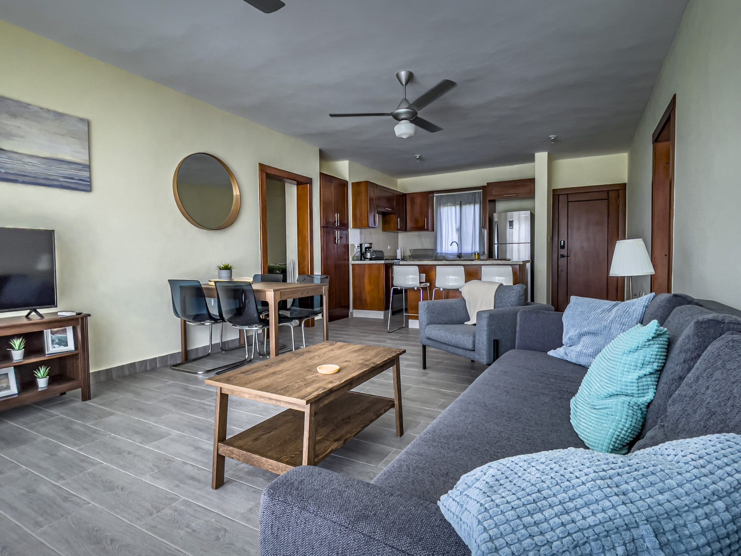 buyDRproperty Living room of a 2 bedroom villa for sale, featuring a sofa, dining area, and kitchen. Sosua Real Estate