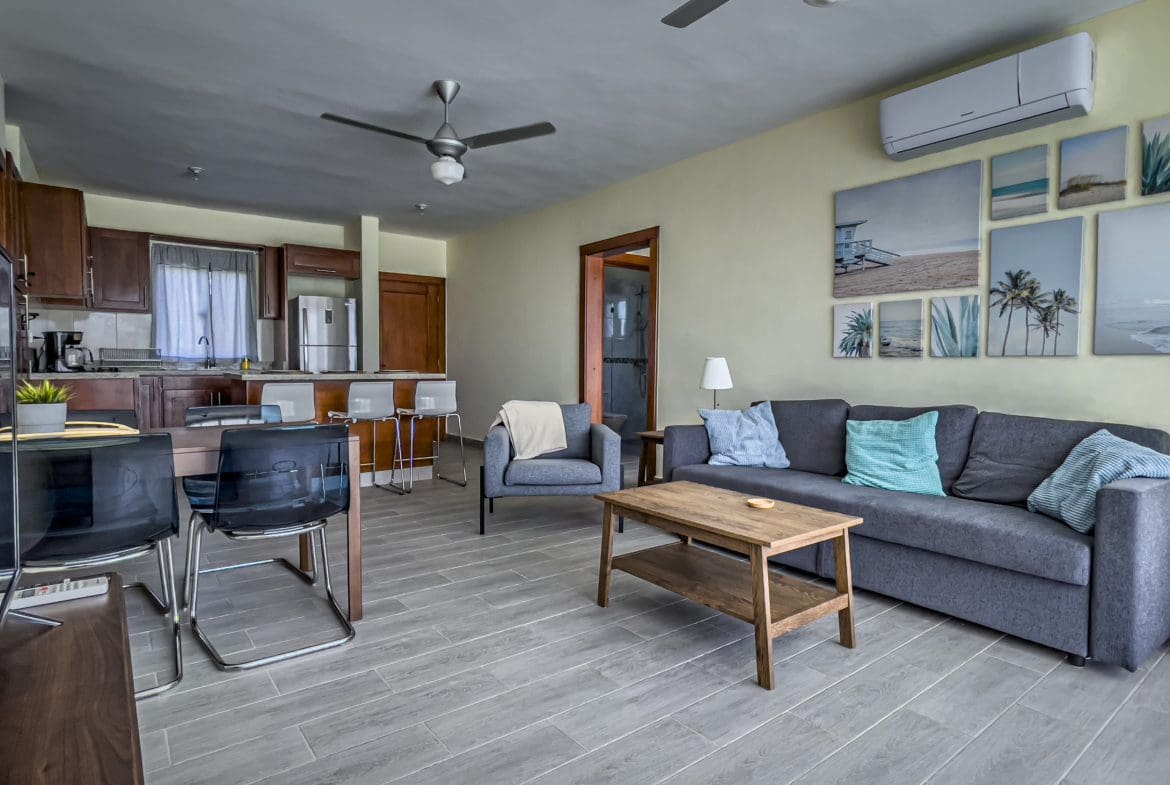 buyDRproperty Living room of a 2 bedroom villa for sale with sofa, table, and artwork. Sosua Real Estate