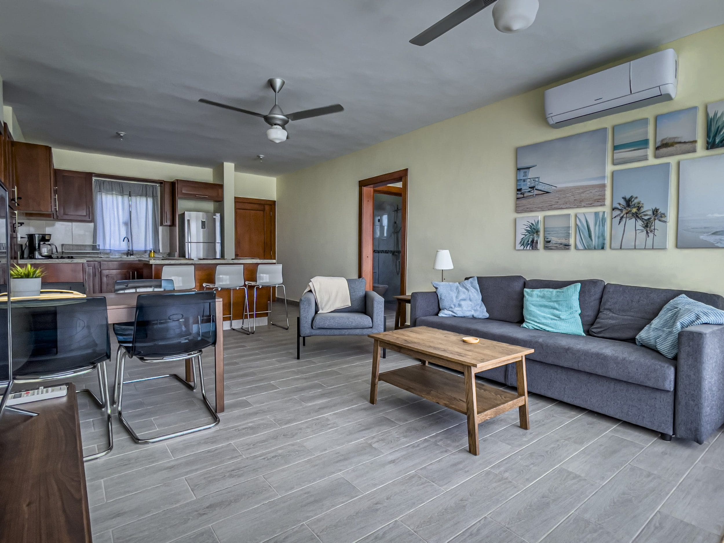 buyDRproperty Living room of a 2 bedroom villa for sale with sofa, table, and artwork. Sosua Real Estate