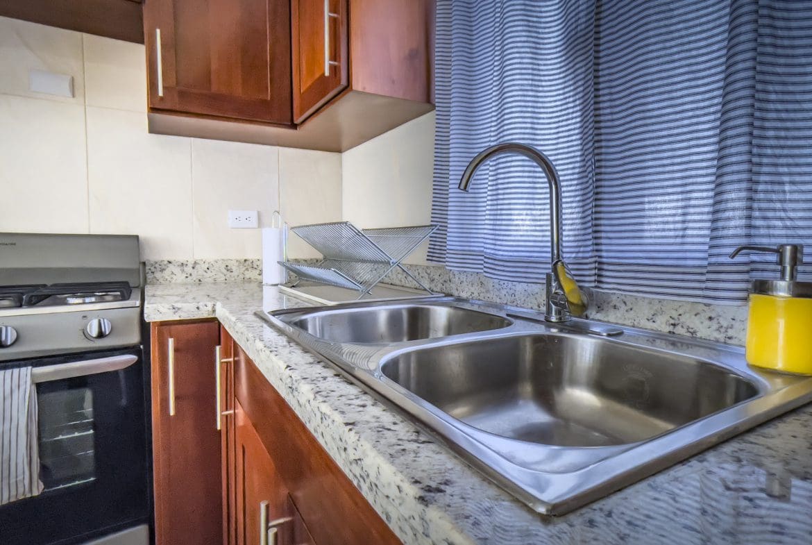 buyDRproperty Kitchen sink in a 2 bedroom villa for sale. Stainless steel sink with granite countertops. Sosua Real Estate