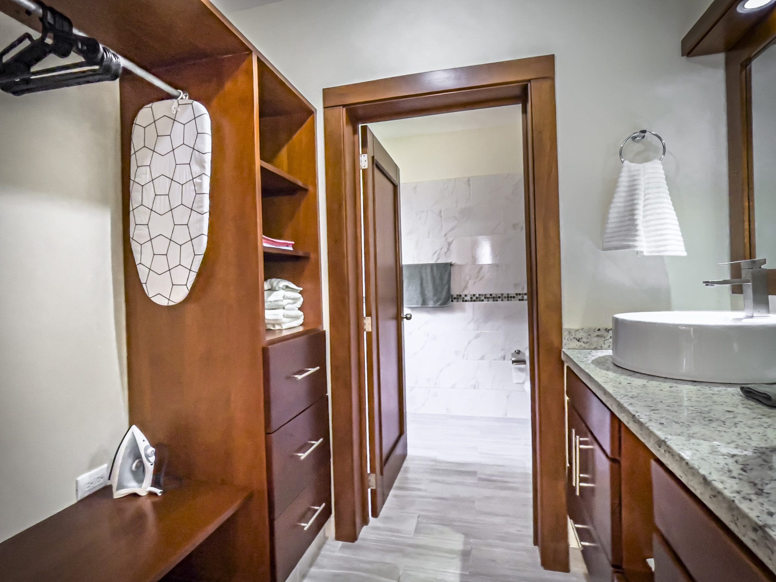 buyDRproperty Wooden closet with ironing board leading to a bathroom in a 2 bedroom villa for sale. Sosua Real Estate