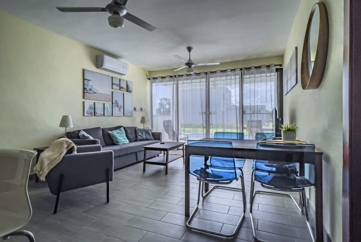 buyDRproperty Modern living room in a 2 bedroom villa for sale with dining table and chairs. Sosua Real Estate